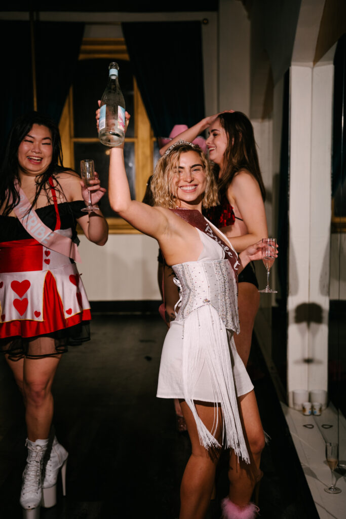 Happy women smiling and celebrating a hens party at The Golden Era Studio in Sydney CBD